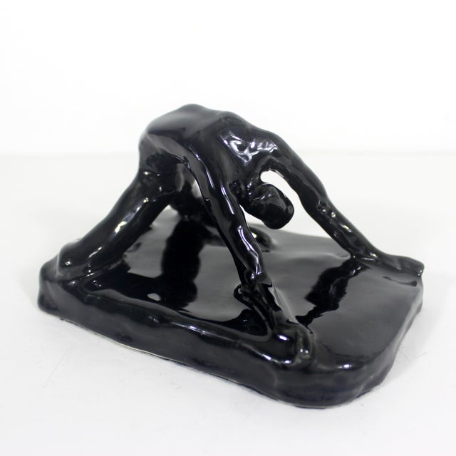 Width: 6 inches Height: 3.25 inches Depth: 4 inches Ceramic sculpture of a female dancer or gymnast with a glossy black...