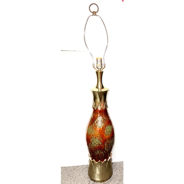 Mid-Century Pottery Ceramic Lamp Spot Glazed in Burnt Orange and Mint Green. Capped in ornate brass sleeves. A uniquely...