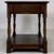 A charming early 20th-century English side table, finely crafted from oak and distinguished by its traditional turned...