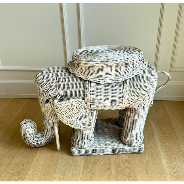 A wonderfully sculptural vintage wicker elephant side table, circa 1970s, handwoven over a sturdy internal frame and...