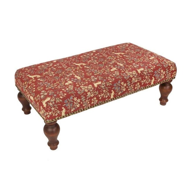 Meticulously handcrafted in the United Kingdom, this upholstered stool boasts classic studding and hand-polished solid...