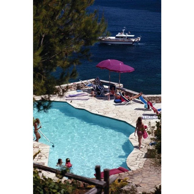 Pellicano Pool 1969 by Slim Aarons Slim Aarons Limited Estate Edition Guests around the pool at the Hotel Il Pellicano at...