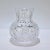 A fine antique small-scale cut glass juice or cocktail pitcher. The body of the pitcher is bulbous or squat (like a...