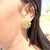 Chiempesa 18K yellow gold earrings featuring a cluster design of polished gold beads. Each earring showcases a central...