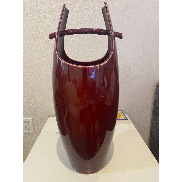 These pieces are an original Jens H Quistgaard (1980-1990) ceramic umbrella stand and matching vase The oxblood red...