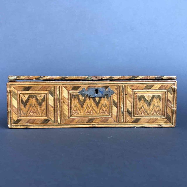 Antique woven straw box built in prisons or monasteries on a wooden frame completely covered in differently colored straw...