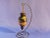 This hand blown reverse hand painted glass ornament was made by the artist Michael Godard who named this piece Lost In...