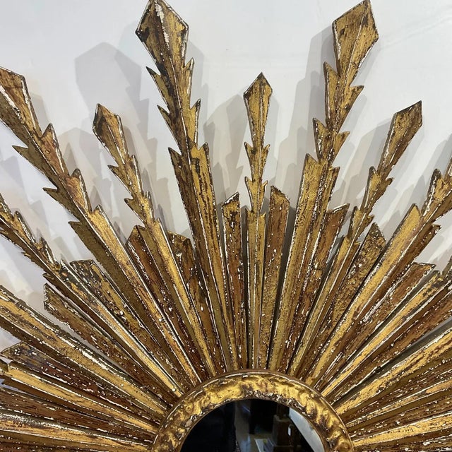 eautiful Italian 19th century vintage sunburst mirror! This is a stunning piece with wooden rays that are hand carved and...