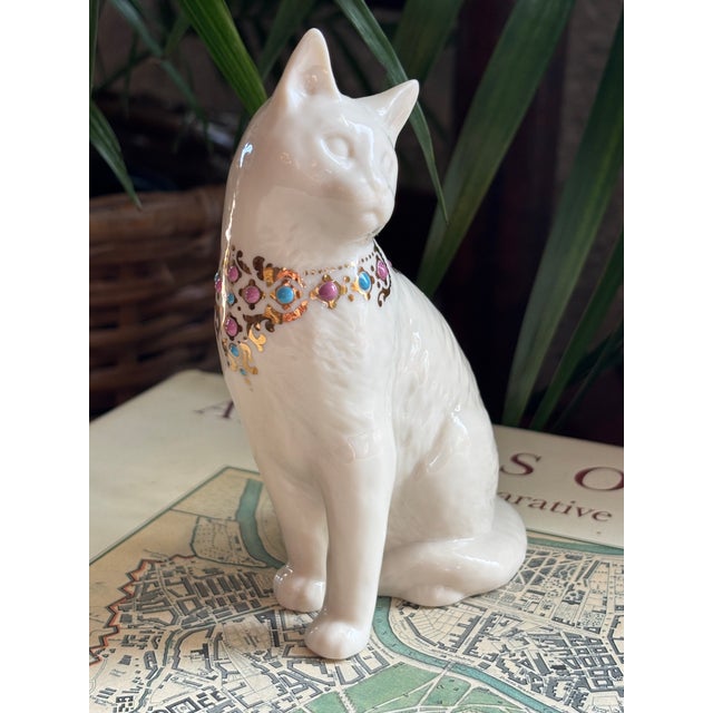 Retired Lenox cat figurine in ivory fine bone china, jeweled with a 24 karat gold trim. Bottom is marked Lenox. Please see...