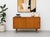 Mid Century Modern oak credenza featuring two sliding doors, solid light oak tapered legs and the simple and clean design...
