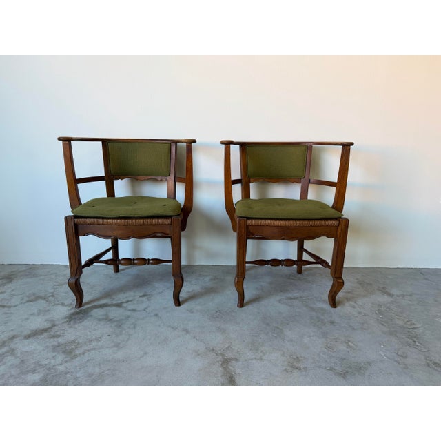 Charming pair of vintage accent chairs featuring an organic Arts & Crafts inspired design with beautifully curved rail...