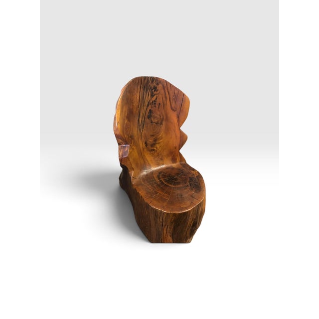 A striking one-of-a-kind sculptural chair carved from an exceptionally large section of solid tree trunk. The chair...