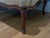 An elegant antique French Louis XV–style upholstered loveseat or settee featuring a beautifully shaped silhouette and...