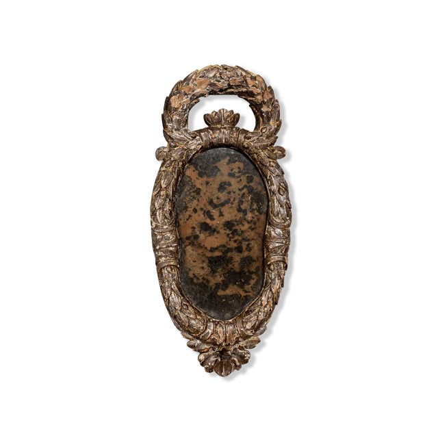 Mirrored sconce with acanthus frame. Silver-leaf finish and heavy foxing.
