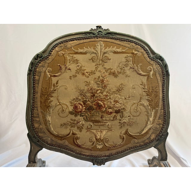 This is an antique French fire screen in the Louis XV style, standing on four gently curved cabriole legs and centered...
