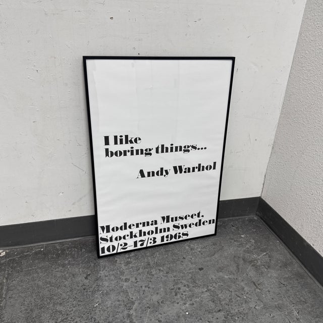 Design Plus Gallery presents an “I Like Boring Things...” exhibition poster by Andy Warhol, framed art print. This graphic...