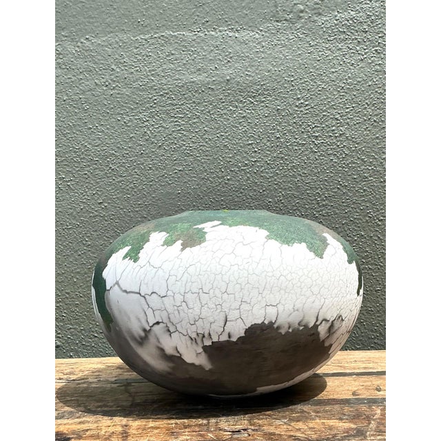 This vintage ceramic vase by Tony Evans showcases his signature crackle glaze technique. The robust, rounded form is...