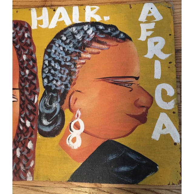 Colorful vintage hair styling sign from Ghana.