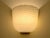 This wall lamp stands out for its modern and clean design: the white glass (milky/satin) is crafted with a "Swirl"...