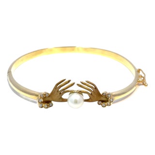 18k Yellow Gold Diamond Hand Holding Pearl Bangle Bracelet For Sale