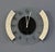 A bold postmodern wall clock signed "empire" on the glass face. Sculptural asymmetric side panels in speckled granite-look...