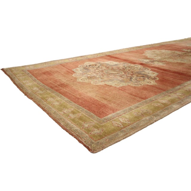 Vintage Turkish Oushak Carpet Runner 05'03" x 12'06". Three dominant medallions quietly float on the abrashed red field of...