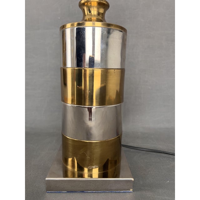 brass and chrome. height without cap 28 cm. base 12 x 12 cm. This piece is attributed to the mentioned designer/maker. It...