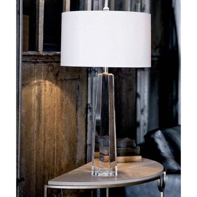 Shed light on the glamorous, contemporary and modern Tapered Hex Crystal table lamp. Featuring a tapered crystal base, a...
