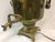 This large classic brass Russian Samovar features several hallmarks stamped in front, sturdy wooden handles and rests on a...
