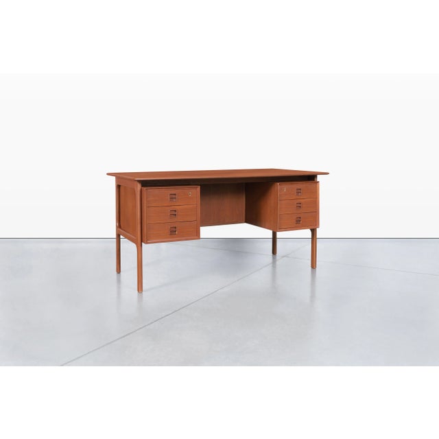 Mid-century modern teak desk designed by Erik Brouer for Brouer Mobelfabrik, Denmark, circa 1960s. Showcasing the refined...