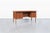 Mid-century modern teak desk designed by Erik Brouer for Brouer Mobelfabrik, Denmark, circa 1960s. Showcasing the refined...