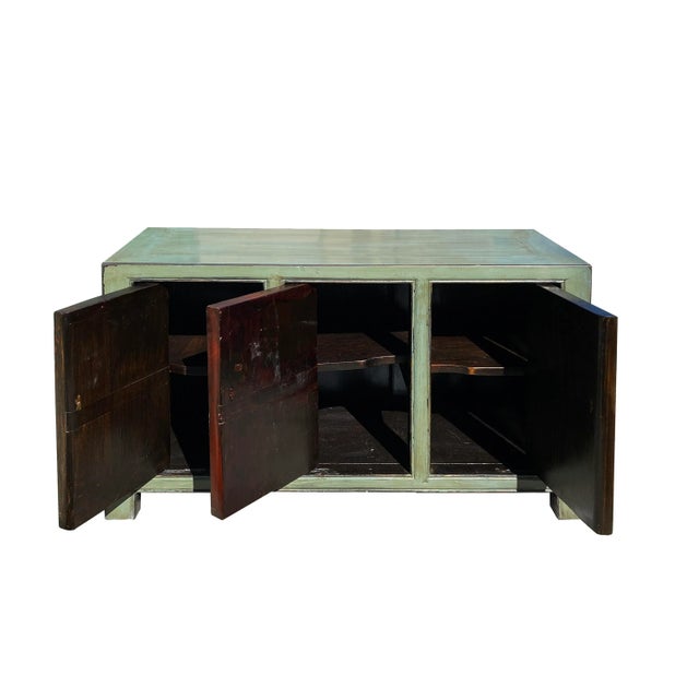 This is a wooden low cabinet with restored floral vases graphic on the orange color doors. The rest of the cabinet is...