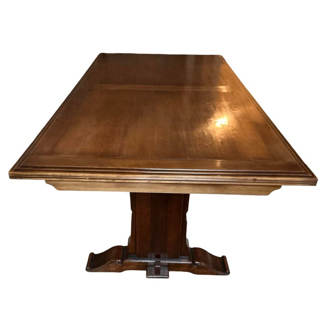 Elegant expandable dining table by Richelieu Art & Meubles de France, crafted in France and featuring a rich warm wood...