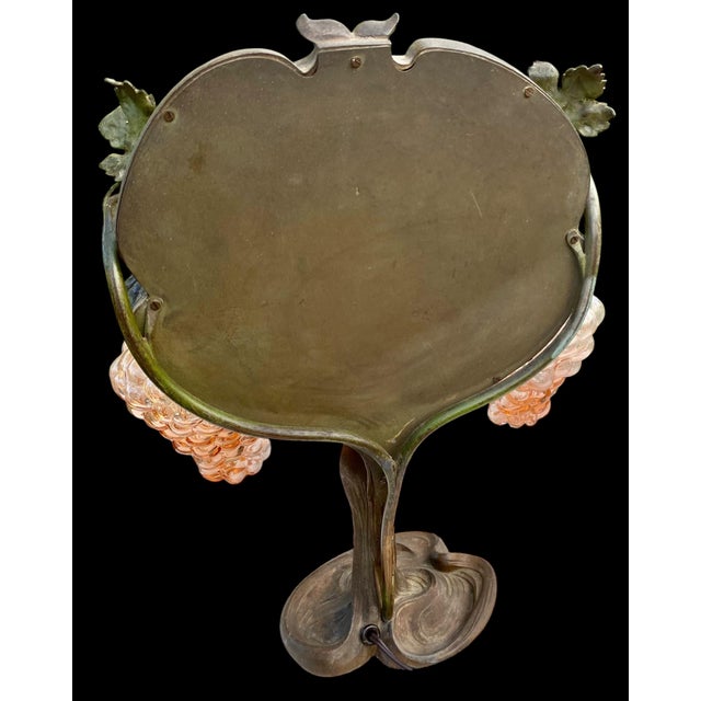 A rare antique Art Nouveau figural table top vanity lamp with the original hand beveled mirror by Georges Van der...