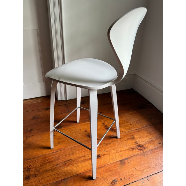 Norman Cherner's iconic 1958 molded plywood stool design, produced under license by The Cherner Chair Company from the...