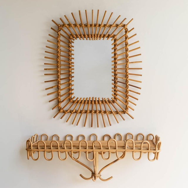 Beautiful rectangular rattan sunburst mirror from France, 1960s. Unique design with rattan detailing encompassing the...