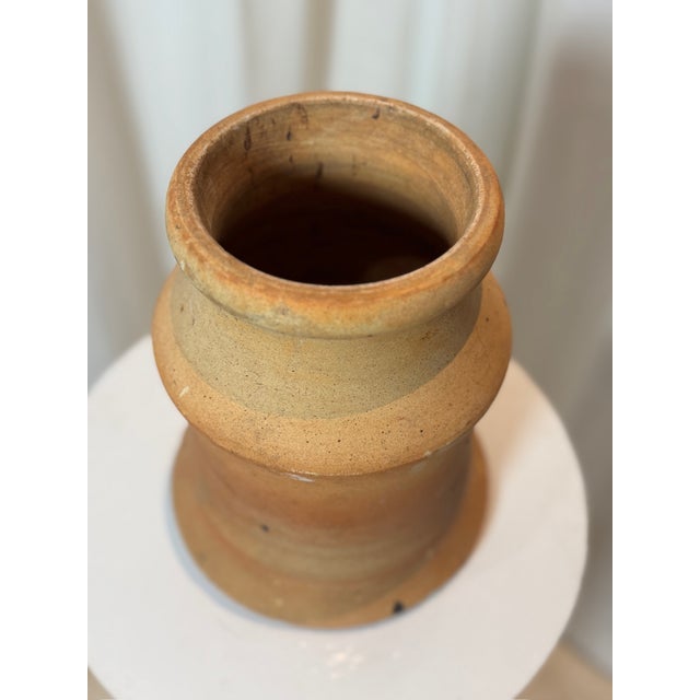 This antique two-piece terracotta vessel is a remarkable example of early handcrafted pottery, featuring an hourglass-...