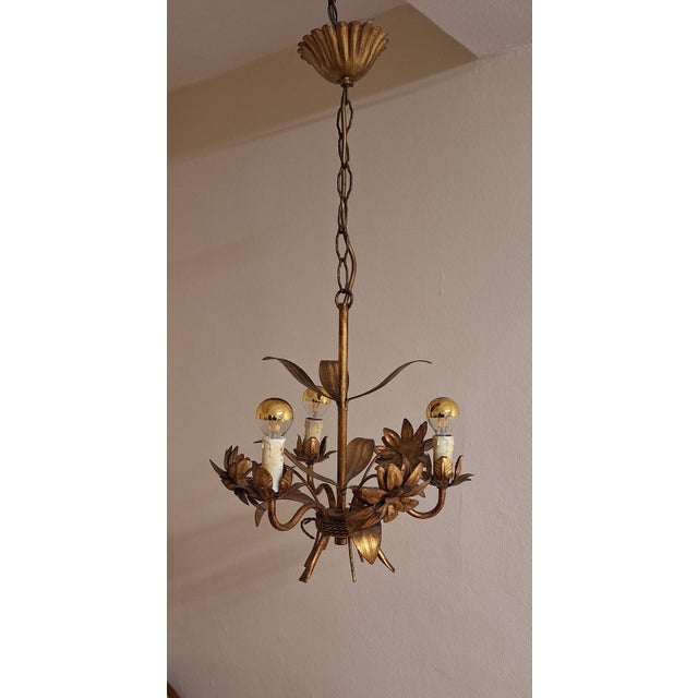 Vintage Chandelier in a Floral Design Made of Gold-Colored Metal, 1970s, in Good conditions. Designed 1970 to 1979...
