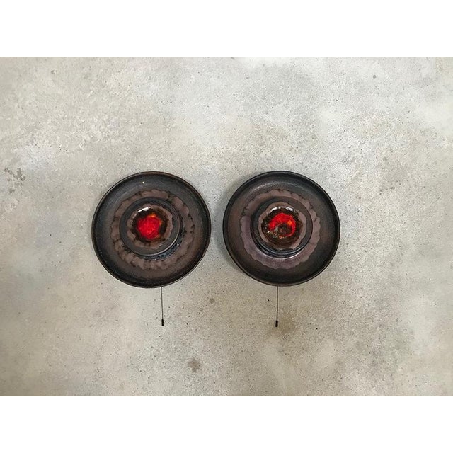 This set of two large round ceramic sconces was manufactured in Scandinavia during the 1960s. The high-quality wall lamps...