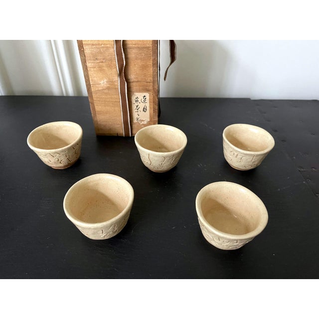A set of five stoneware sencha tea cups by Otagaki Rengetsu (1791-1875). These miniature cups were simply molded in the...
