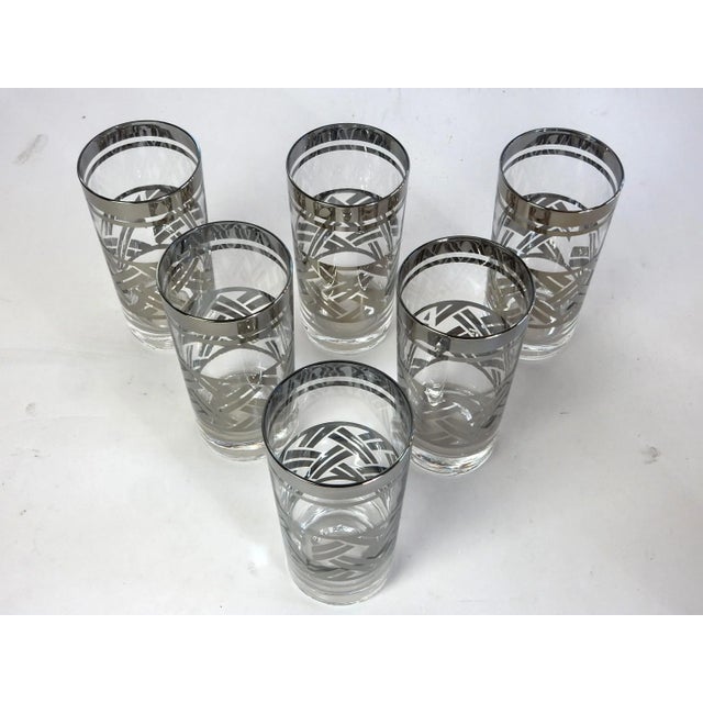 Gorgeous set of 6 mid century cocktail glasses with a chrome banded rim and basket weave pattern on sides. This set looks...