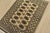 A tribal Bokhara rug hand-knotted with fine wool on a cotton foundation. This rug features rows of repeating medallions...