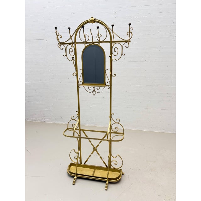 An exceptional freestanding coat rack made of cold-forged iron, dating from 1956. The elaborately crafted piece is...