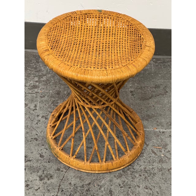 Design Plus Gallery presents a Vintage Rattan Hourglass Stool. A rounded woven rattan seat sits above an open lattice...