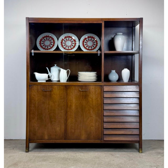 A stunning vintage mid-century modern "Dania" collection display cabinet by Merton Gershun for American of Martinsville,...