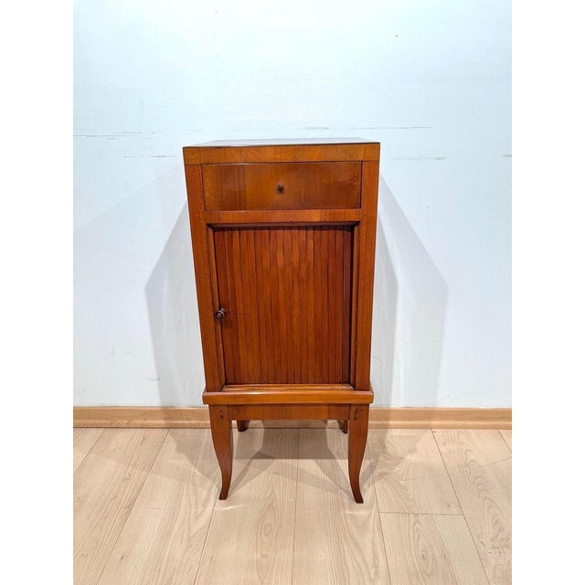 Biedermeier pillar cabinet or small furniture with shutter sliding door from south germany around 1820. cherry wood...