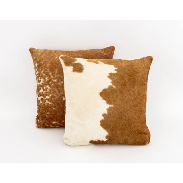 Pair of Modern Cowhide Throw Pillows, each with zipper closure. 18.5" L x 18.5" W x 6.5" D. Provenance: From a SoHo, New...