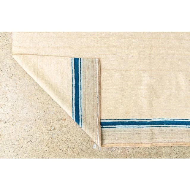This vintage handmade Moroccan Berber kilim rug or blanket is handcrafted from hand-spun wool. It features a natural beige...