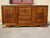 Large solid walnut sideboard with straight, rectilinear curves. Three solid wood cupboard doors with a central motif and...