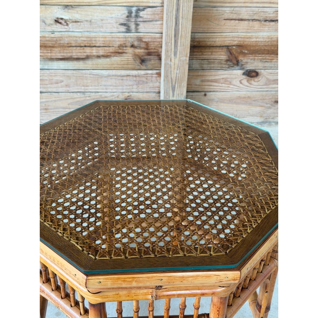 Beautiful vintage octagonal bamboo side table featuring an intricate woven cane inset top, decorative bamboo spindle...